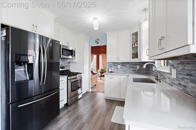24462 Christian Dr, Flat Rock, MI 48134 - kitchen featuring stainless steel appliances, light countertops, white cabinets, backsplash, and glass insert cabinets