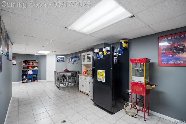 24462 Christian Dr, Flat Rock, MI 48134 - kitchen with freestanding refrigerator, a drop ceiling, and white cabinets