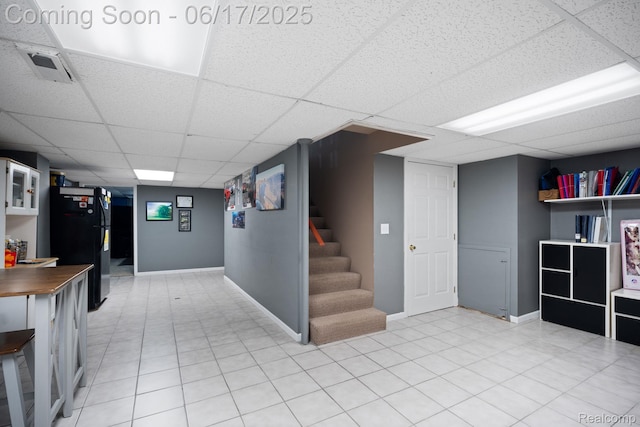 24462 Christian Dr, Flat Rock, MI 48134 - finished below grade area with a paneled ceiling, freestanding refrigerator, and stairway