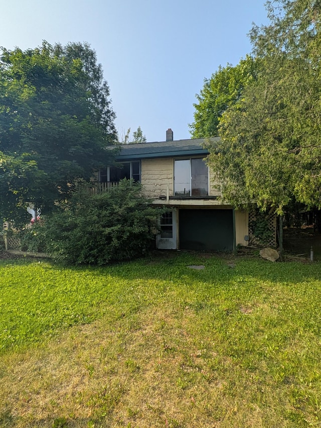 4989 W Jordan Rd, Weidman, MI 48893 - rear view of house featuring a lawn and a chimney