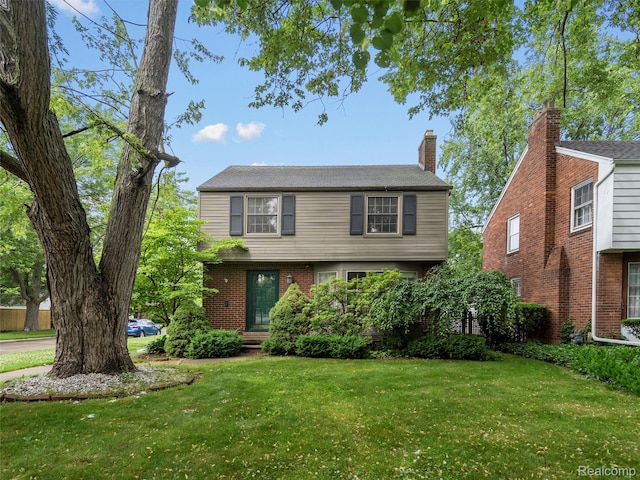 1930 Kenmore Dr, Grosse Pointe Woods, MI 48236 - colonial-style house featuring a front yard and brick siding