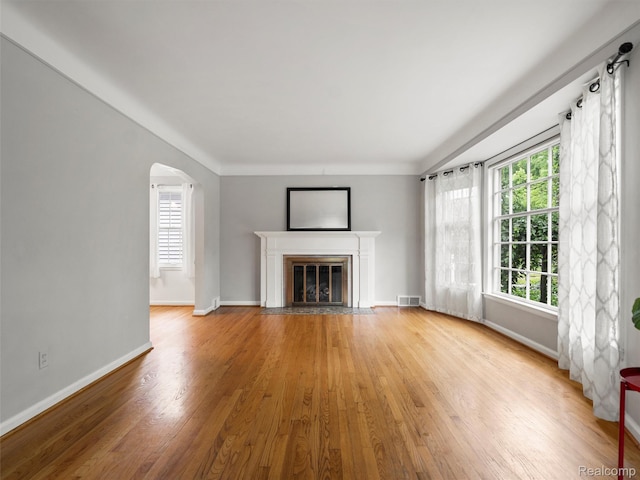 1930 Kenmore Dr, Grosse Pointe Woods, MI 48236 - unfurnished living room with wood finished floors, healthy amount of natural light, and a fireplace with flush hearth