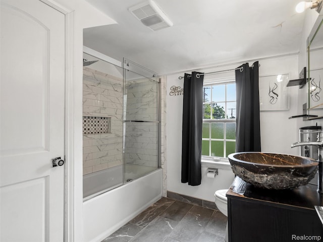 1930 Kenmore Dr, Grosse Pointe Woods, MI 48236 - bathroom with vanity, marble look tiles, and bath / shower combo with glass door