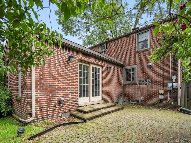 1930 Kenmore Dr, Grosse Pointe Woods, MI 48236 - rear view of property featuring brick siding, a patio area, and crawl space