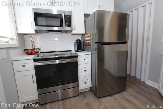 1670 Graefield Rd, Birmingham, MI 48009 - kitchen with stainless steel appliances, wood finished floors, light countertops, and white cabinets
