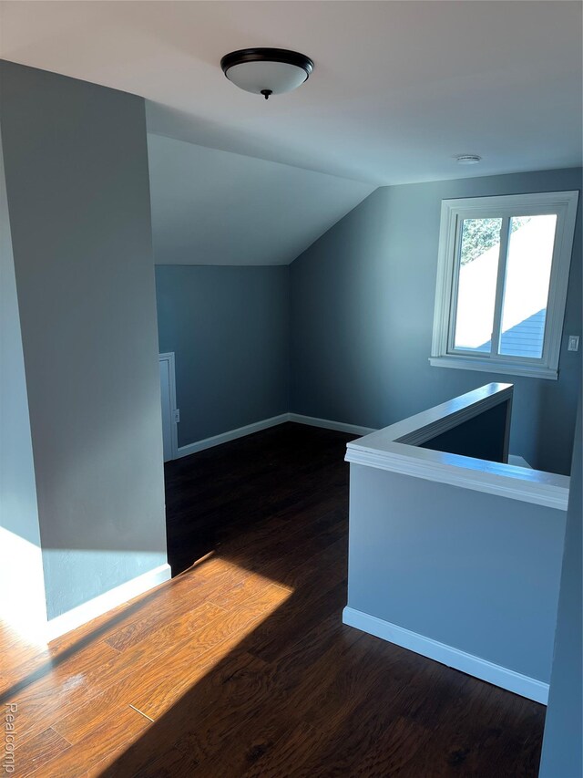 44 Pleasantview Dr, Pontiac, MI 48341 - additional living space with dark wood-style flooring and vaulted ceiling