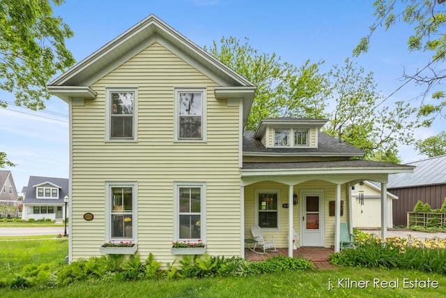 7115 Bronson St SE, Ada, MI 49301 - view of front of house featuring covered porch and a front yard