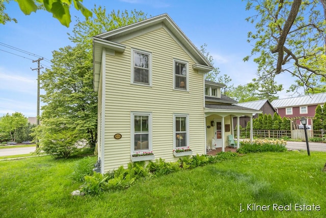 7115 Bronson St SE, Ada, MI 49301 - view of front facade with a front yard and covered porch