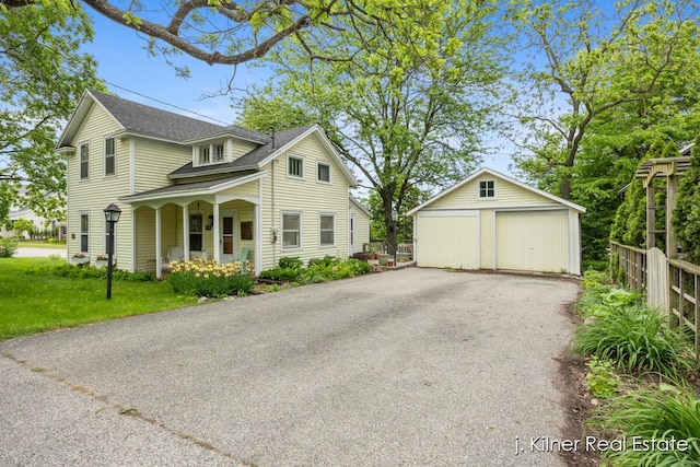 7115 Bronson St SE, Ada, MI 49301 - traditional home with a detached garage, an outdoor structure, a shingled roof, and a porch