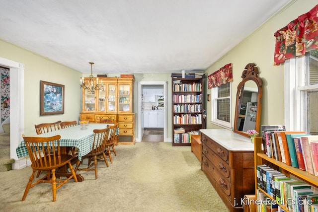 7115 Bronson St SE, Ada, MI 49301 - dining area featuring a chandelier and light colored carpet