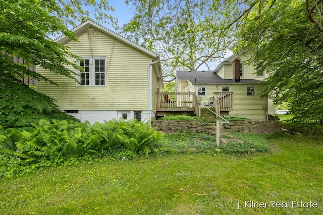 7115 Bronson St SE, Ada, MI 49301 - back of house featuring a deck and a yard
