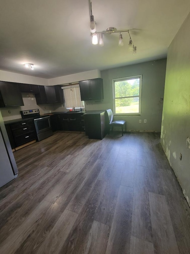 14300 Tuttlehill, Milan, MI 48160 - kitchen featuring stainless steel electric range, dark wood-type flooring, track lighting, and dark cabinetry