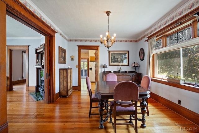 203 S Main St, Onsted, MI 49265 - dining room with light wood-style floors, a chandelier, and ornamental molding