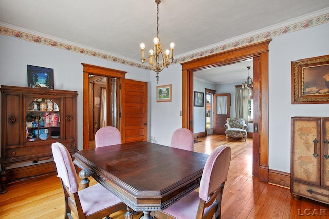 203 S Main St, Onsted, MI 49265 - dining space with a chandelier, light wood-type flooring, and ornamental molding