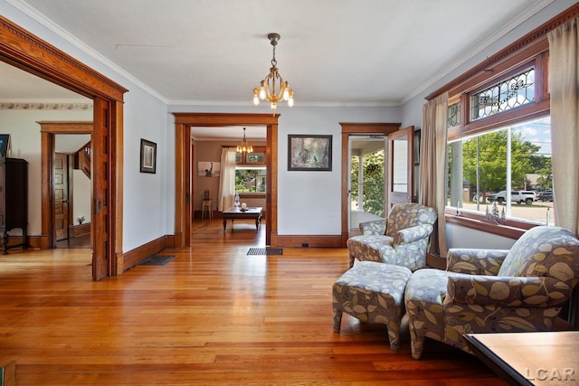 203 S Main St, Onsted, MI 49265 - sitting room featuring a chandelier, light wood finished floors, and ornamental molding