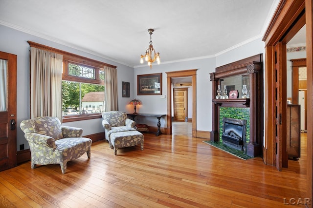 203 S Main St, Onsted, MI 49265 - living area with light wood-type flooring, a chandelier, a tile fireplace, and ornamental molding