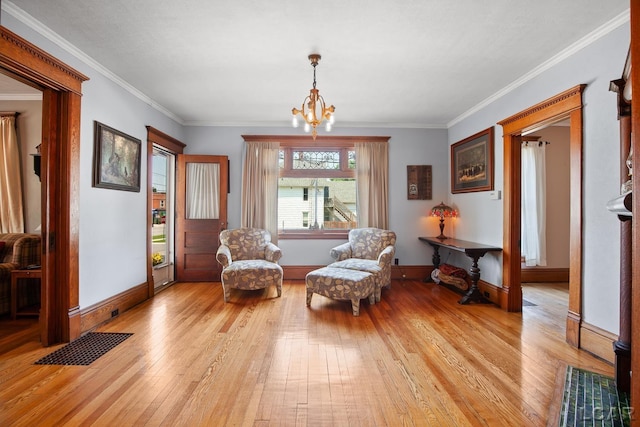 203 S Main St, Onsted, MI 49265 - living area featuring light wood-style flooring, crown molding, and a chandelier