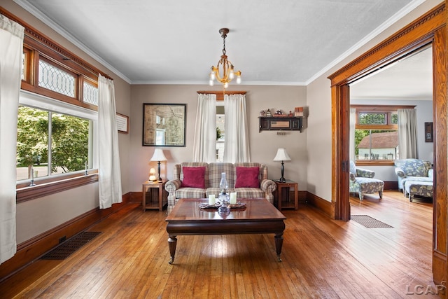 203 S Main St, Onsted, MI 49265 - living area featuring hardwood / wood-style flooring, a chandelier, and ornamental molding