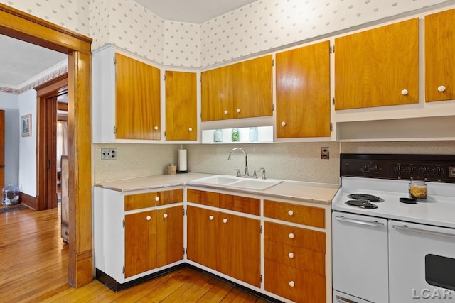 203 S Main St, Onsted, MI 49265 - kitchen with white electric range, light countertops, light wood-type flooring, and decorative backsplash