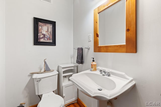 203 S Main St, Onsted, MI 49265 - half bath featuring toilet and a sink