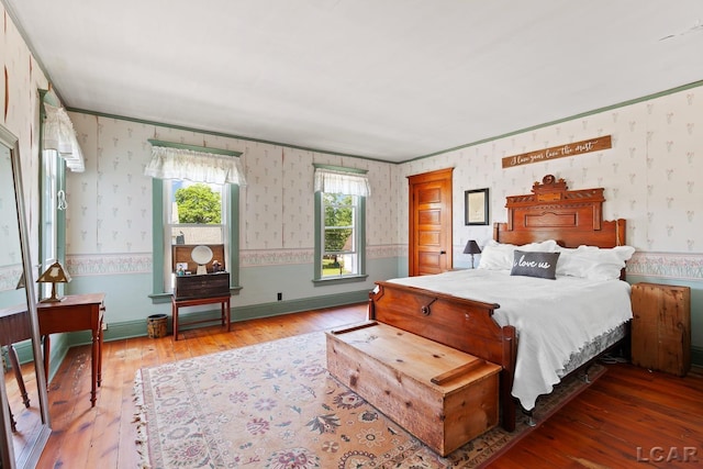 203 S Main St, Onsted, MI 49265 - bedroom with wallpapered walls, hardwood / wood-style floors, and crown molding