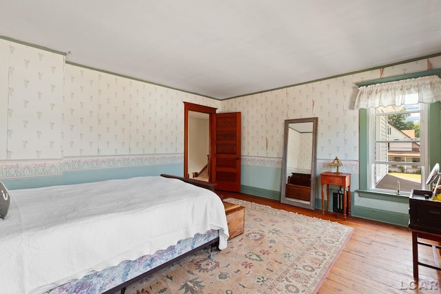 203 S Main St, Onsted, MI 49265 - bedroom featuring wood-type flooring and wallpapered walls