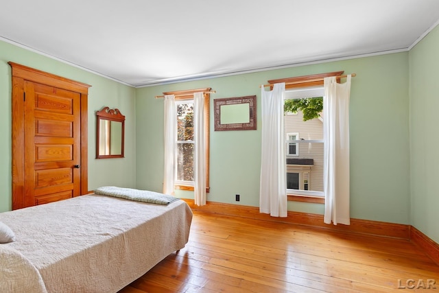 203 S Main St, Onsted, MI 49265 - bedroom featuring light wood finished floors and crown molding