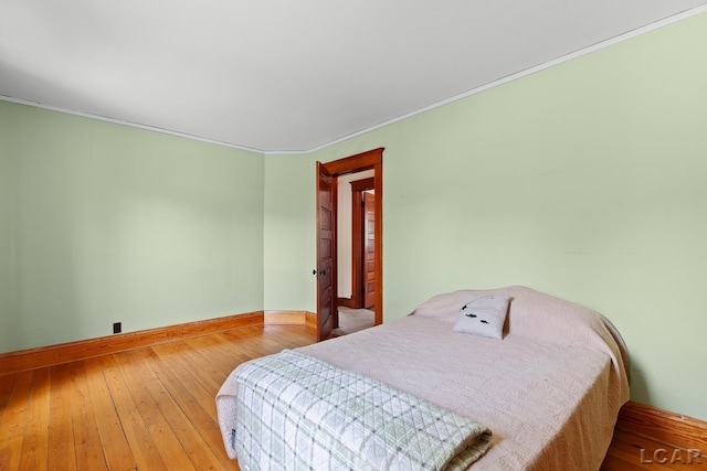 203 S Main St, Onsted, MI 49265 - bedroom featuring hardwood / wood-style flooring and crown molding