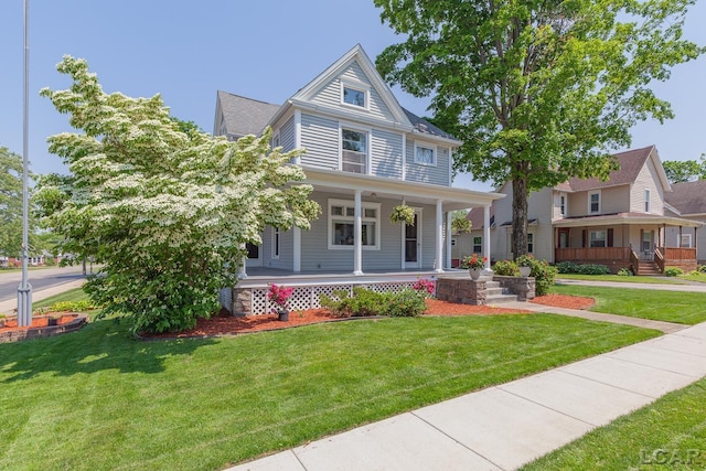 203 S Main St, Onsted, MI 49265 - view of front of home featuring a porch and a front lawn
