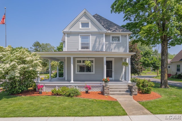 203 S Main St, Onsted, MI 49265 - view of front of house featuring a porch and a front yard