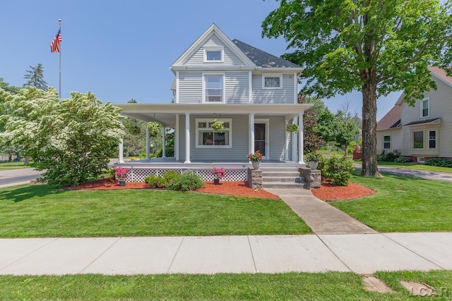 203 S Main St, Onsted, MI 49265 - view of front of house featuring a porch and a front yard