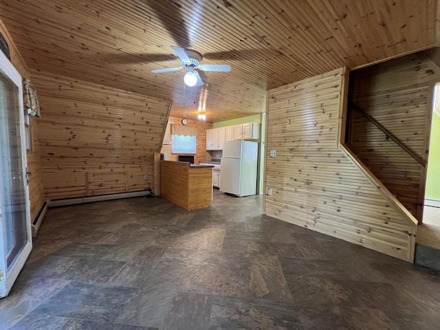 7428 Ansley Ln, Hillsdale, MI 49242 - unfurnished living room with wooden walls, baseboard heating, ceiling fan, and wood ceiling