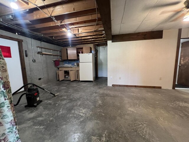 7428 Ansley Ln, Hillsdale, MI 49242 - unfinished below grade area with freestanding refrigerator and baseboards