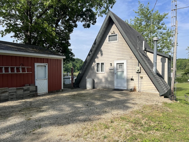 7428 Ansley Ln, Hillsdale, MI 49242 - rear view of house with roof with shingles and an outbuilding