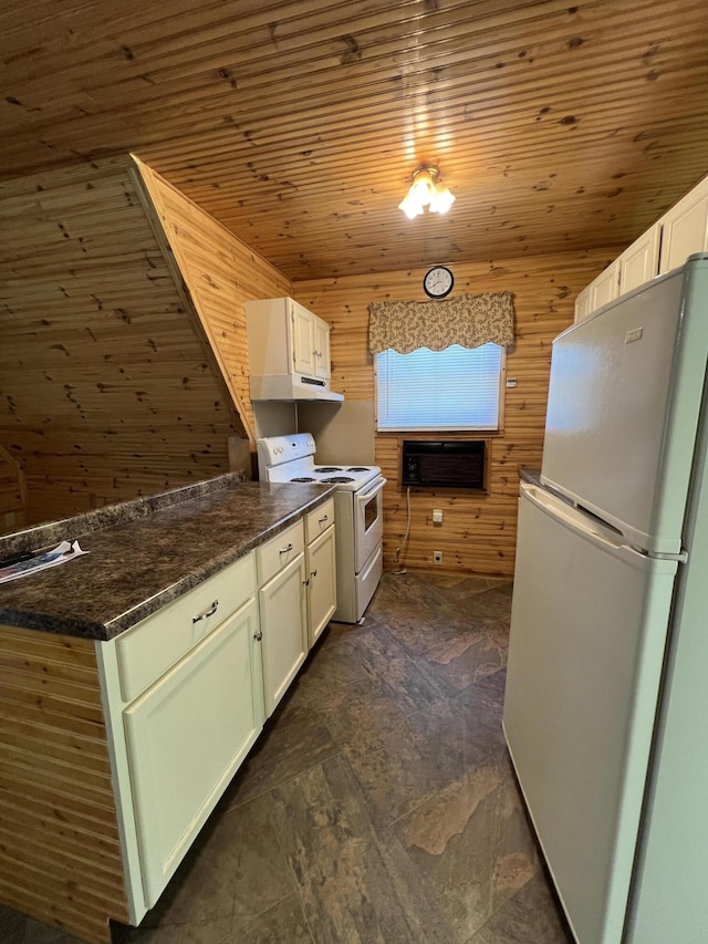 7428 Ansley Ln, Hillsdale, MI 49242 - kitchen with white appliances, wood walls, dark countertops, white cabinets, and dark stone finish floors