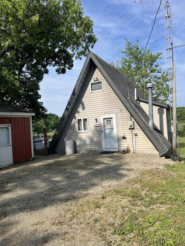 7428 Ansley Ln, Hillsdale, MI 49242 - back of property with an outdoor structure and a shingled roof