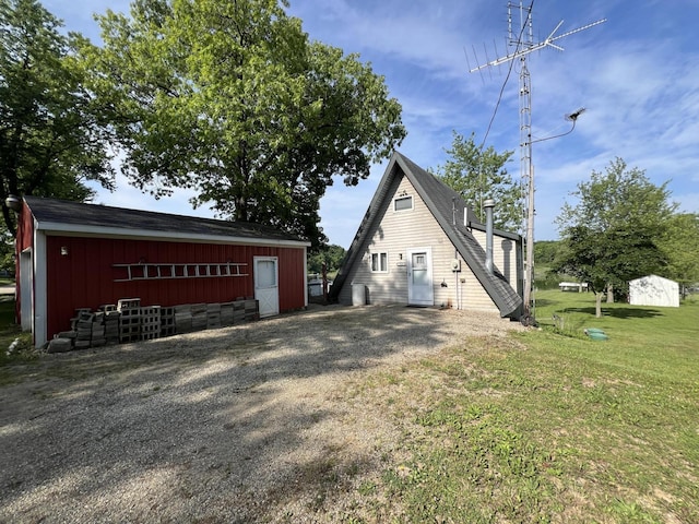 7428 Ansley Ln, Hillsdale, MI 49242 - view of side of property with an outbuilding, a yard, a pole building, and board and batten siding