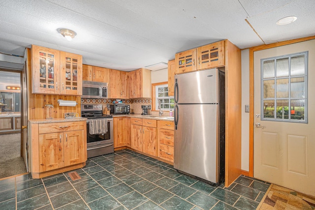 8933 E M 20, Hesperia, MI 49421 - kitchen with stainless steel appliances, light countertops, glass insert cabinets, and a textured ceiling