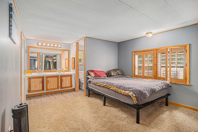 8933 E M 20, Hesperia, MI 49421 - bedroom with a textured ceiling and light wood-type flooring