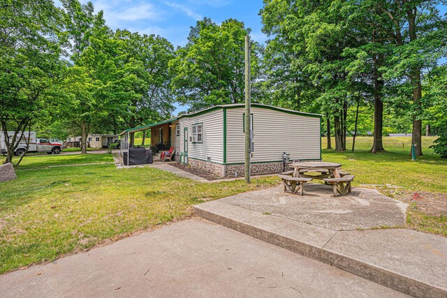 8933 E M 20, Hesperia, MI 49421 - view of green lawn with a patio