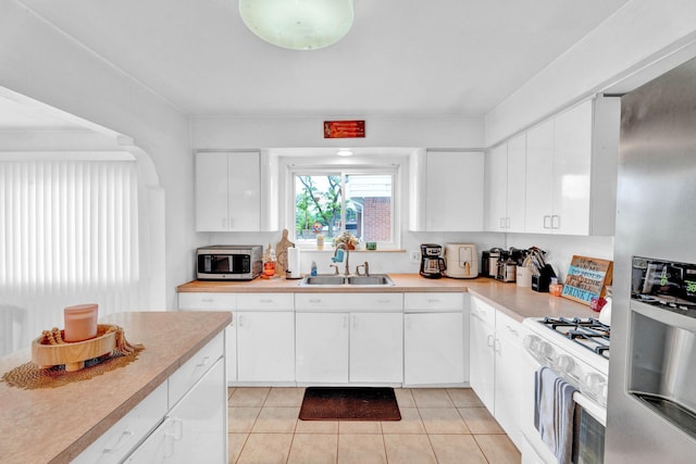 29206 Guy St, Southfield, MI 48076 - kitchen with appliances with stainless steel finishes, light tile patterned floors, and light countertops