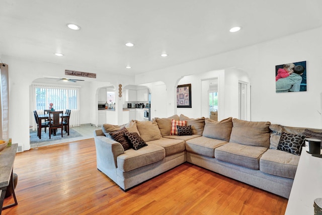 29206 Guy St, Southfield, MI 48076 - living area with arched walkways, light wood-style floors, recessed lighting, and ceiling fan