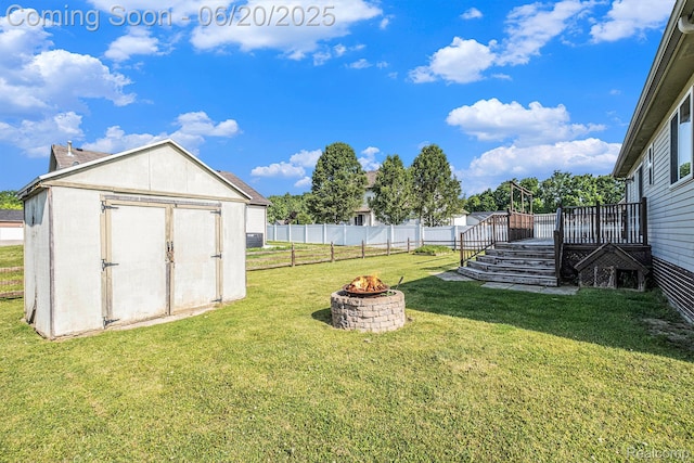 2274 Apple Tree Dr, Burton, MI 48519 - fenced backyard with an outdoor fire pit, a storage unit, and a wooden deck