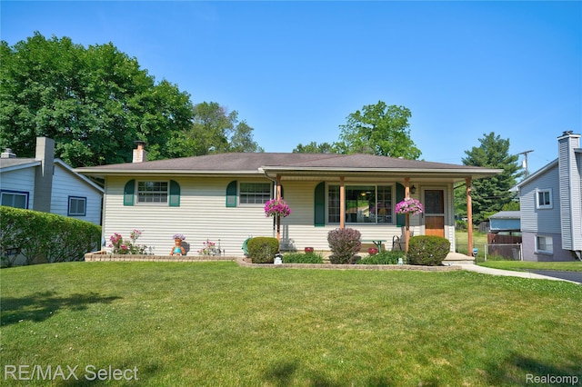2249 Pauline Dr, Waterford, MI 48329 - view of front of home featuring a front yard, a chimney, and covered porch