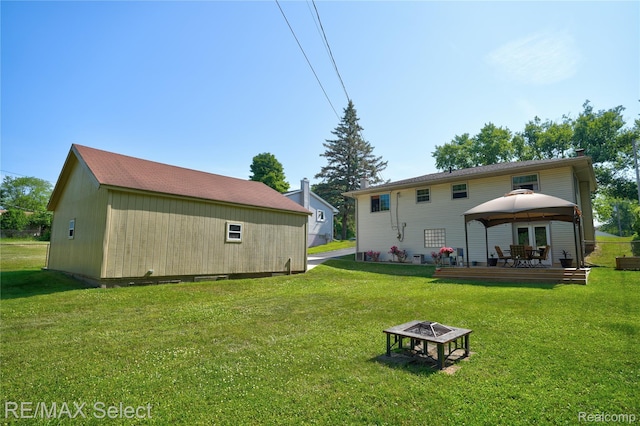 2249 Pauline Dr, Waterford, MI 48329 - back of property featuring a gazebo, an outdoor fire pit, and a yard