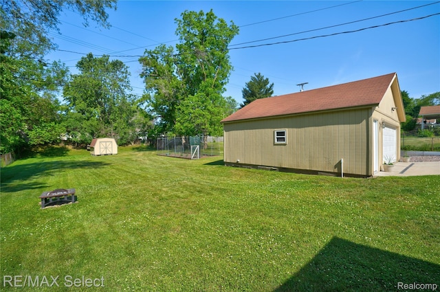 2249 Pauline Dr, Waterford, MI 48329 - view of yard with an outdoor fire pit, a detached garage, and a storage shed