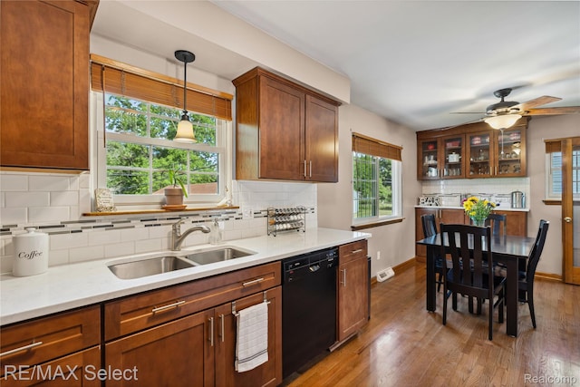 2249 Pauline Dr, Waterford, MI 48329 - kitchen with dishwasher, wood finished floors, backsplash, and light countertops