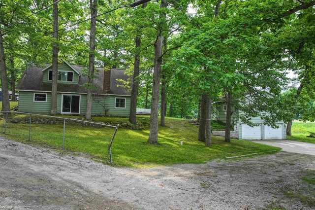 7199 Switzer Dr, Linden, MI 48451 - view of front of home featuring a garage, concrete driveway, a chimney, and a shingled roof