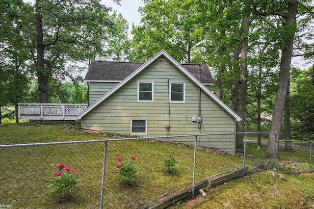 7199 Switzer Dr, Linden, MI 48451 - view of side of home featuring a fenced backyard, a deck, and a shingled roof