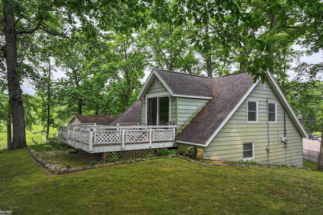 7199 Switzer Dr, Linden, MI 48451 - back of house featuring roof with shingles, a yard, and a wooden deck